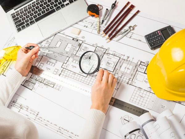 architect-making-plan-with-loupe_23-2147710957